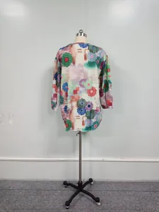 Back view of a long-sleeve women's blouse featuring abstract colorful floral prints