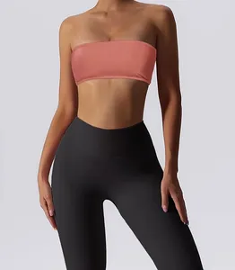 Close-up detail of the peach strapless bandeau sports bra with a seamless texture