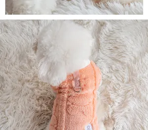 Detail view of a cozy peach fleece dog vest with a metal leash attachment ring