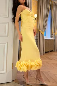 Side view of elegant yellow slim fit evening dress with ruffled hem and bodice detail