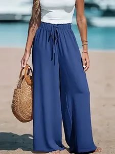 Detailed view of breathable blue wide-leg pants featuring a high waist drawstring design