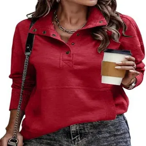 Detailed view of women's red sweatshirt with buttoned stand collar and front pocket