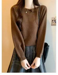 Close-up of brown soft knit sweater with unique diagonal asymmetric neckline detail