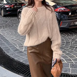 Detailed view of cream crew neck cable knit sweater for women in autumn street style