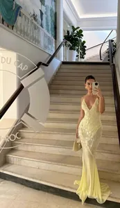 Elegant yellow V-neck sequined mermaid gown with backless camisole design for parties