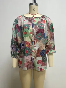 Front view of a vibrant colorful floral print casual blouse for women on a mannequin.