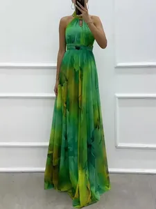 Elegant halter neck sleeveless maxi dress with green vibrant abstract floral print.