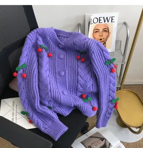 Detailed texture of purple knit cardigan with 3D cherry motifs and cable knit patterns