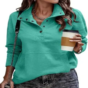 Detailed view of women's casual turquoise sweatshirt featuring button stand-up collar