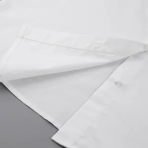 Detailed macro shot of the high-quality stitching and fabric texture on a white shirt
