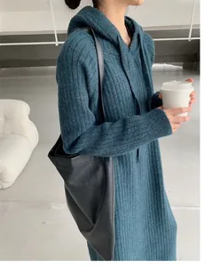 Detailed side view of a cozy blue hooded knitted midi dress for autumn and winter