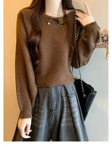 Detail of soft brown knitted sweater with unique asymmetrical neckline and pleats.