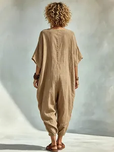 Back view of a loose-fitting khaki linen-blend jumpsuit with gathered harem cuffs.