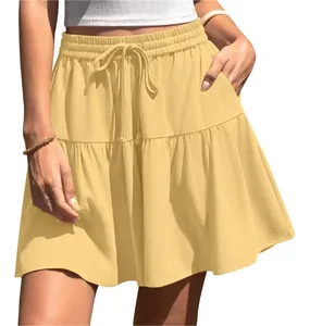 Detailed macro view of the ruffled hem and textured fabric on a yellow summer mini skirt