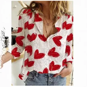 Women's casual white long-sleeved shirt featuring a vibrant red heart print pattern