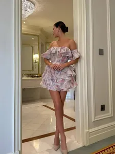 Elegant off-the-shoulder ruffled floral mini dress perfect for a chic and stylish summer look.