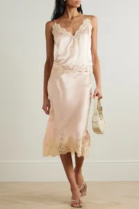 Elegant champagne satin loungewear set with delicate lace trim on camisole and skirt.