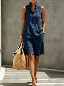 Close-up of a women's navy blue linen sleeveless top and shorts set in a sunny outdoor setting