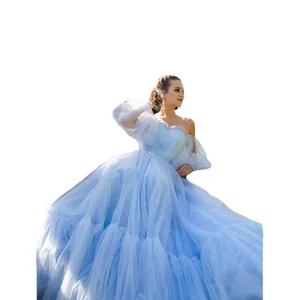 Elegant light blue off-the-shoulder tulle ball gown with puff sleeves for wedding party.