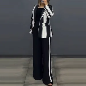 Detailed view of women's elegant black and white striped blazer and wide-leg trousers set