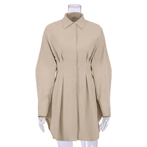 Detailweergave van beige overhemdjurk met lange mouwen en elegante getailleerde taille