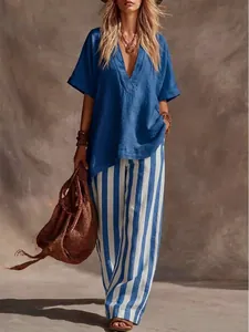 Casual two-piece set featuring a loose blue V-neck top and vertical striped wide-leg pants