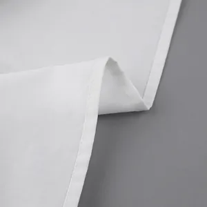 Close-up of high-quality white cotton fabric and neat stitching on a lady's shirt