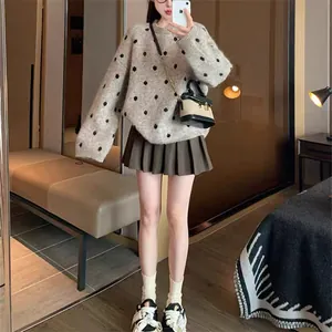 Dettaglio ravvicinato di un maglione vintage a pois con design oversize rilassato