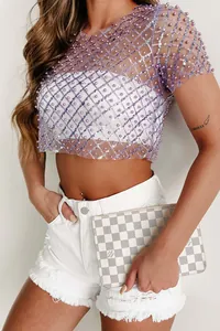 Close-up of sexy mesh top with intricate purple pearl and sequin embroidery