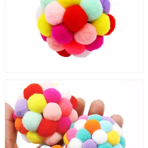 Detail of colorful plush cat toy balls showing soft texture and hand-held scale