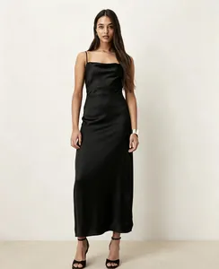 Full-length detail shot of an elegant black cowl neck satin slip dress on a model