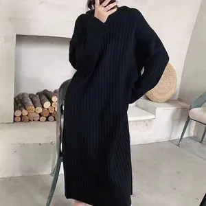 Detail shot of black hooded ribbed knit dress featuring its cozy oversized texture