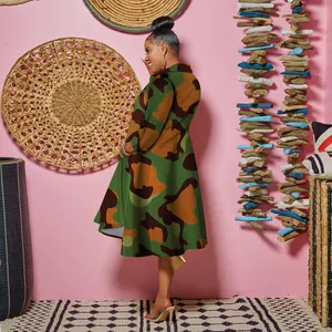 Side view of woman wearing elegant camouflage midi dress with collar and A-line silhouette