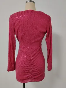 Back view of a hot pink sequined long-sleeve evening dress with detailed ruching.