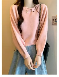 Upper body view of a soft pink sweater showcasing its unique diagonal knot collar design