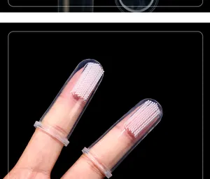Close-up detail of soft silicone pet finger toothbrushes on fingers for gentle dog oral care