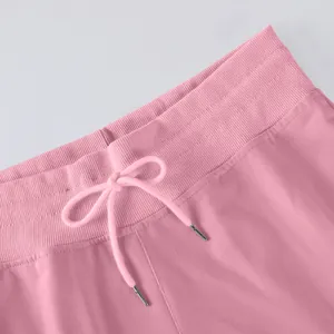 Close-up of pink high waist pants ribbed waistband and drawstring detail