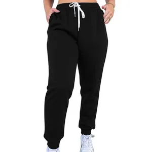 Detail view of women's high-waisted black sweatpants with white drawstring closure
