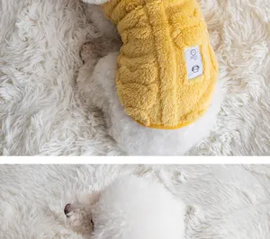 Close-up detail of a soft yellow textured fleece dog vest on a fluffy white poodle