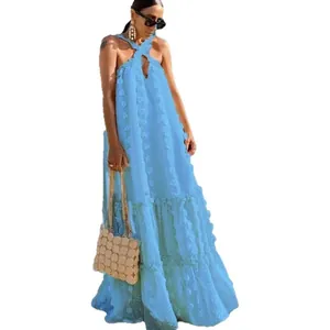 Elegant blue halter neck maxi dress featuring 3D floral texture and a tiered cake style hem