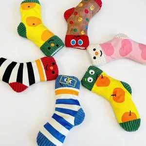 Detailed view of colorful squeaky plush sock toys for small and medium sized dogs