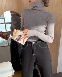 Detailed view of the gray ribbed knit texture and the stylish high turtleneck sweater design