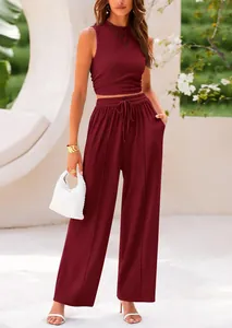 Burgundy ribbed knit two-piece set featuring sleeveless crop top and wide-leg trousers