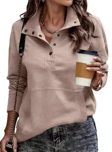 Detail view of casual women's beige sweatshirt with button collar and front pocket