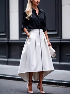 Full length side view of an elegant irregular hem white midi skirt with front zipper and pockets