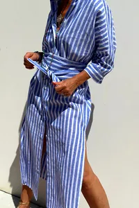 Detail view of a blue and white striped shirt dress with a tie waist and side slit.