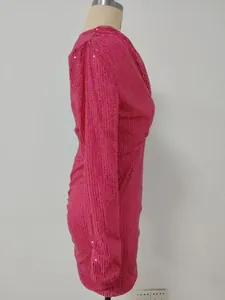 Side profile of a hot pink sequined long-sleeve V-neck party dress shown on a mannequin.