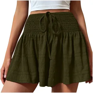 Macro view of olive green smocked waist shorts with decorative drawstring detail