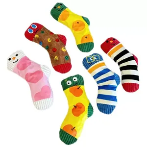 Collection of six colorful plush squeaky dog toy socks with cute cartoon faces and textures