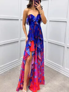Elegant strapless mesh maxi dress with vibrant red and blue floral print and high slit